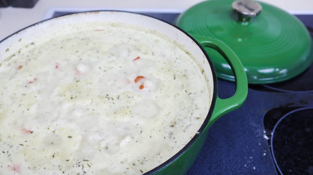 pot of boiling creamy garlic chicken & rice soup 
