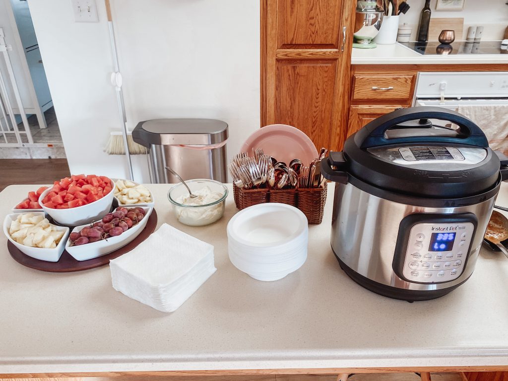 chopped fruit and an instant pot sitting on a counter