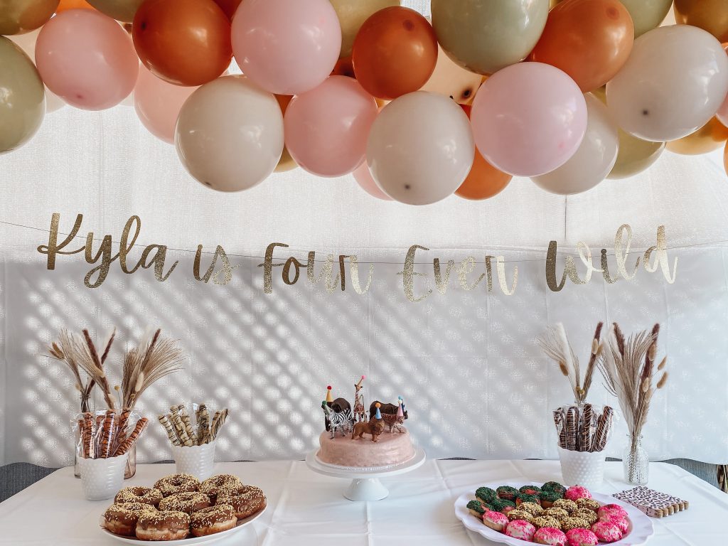 Dessert table with a Four Ever Wild Themed Birthday Banner