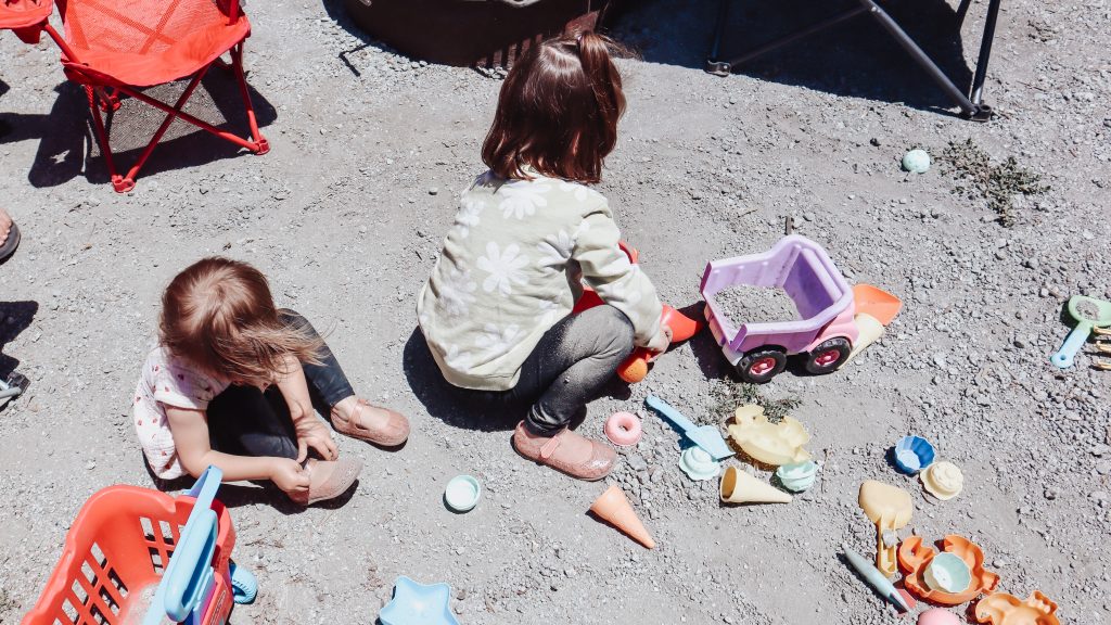 Two children playing with sand toys