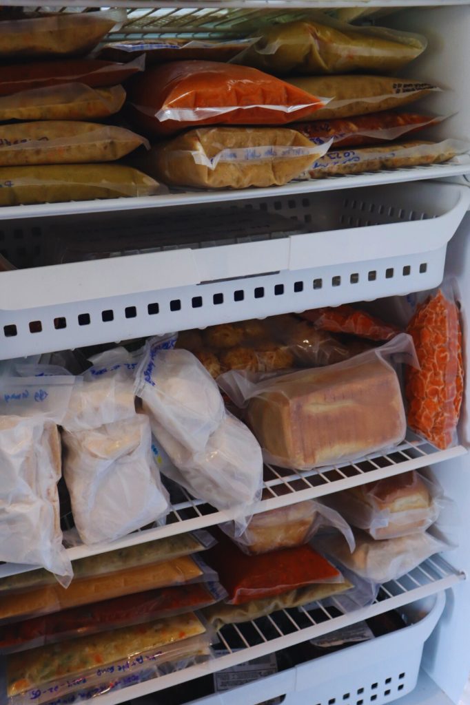 A freezer full of frozen meals on shelves